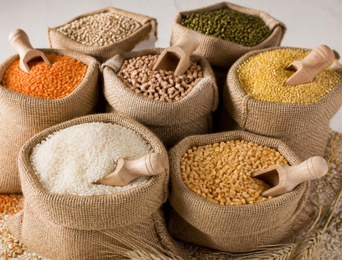 Sacks of rice, pulses, lentils and millets with wooden scoops